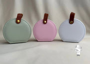 Round leather jewelry organizer with clasp closure and leather handle