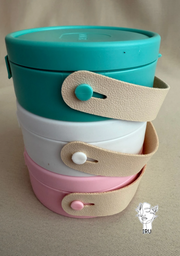 Round plastic jewelry organizer with secure closure and leather handle