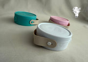 Round plastic jewelry organizer with secure closure and leather handle