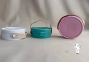 Round plastic jewelry organizer with secure closure and leather handle