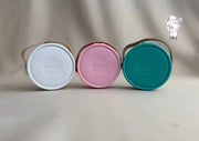 Round plastic jewelry organizer with secure closure and leather handle