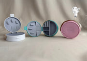 Round plastic jewelry organizer with secure closure and leather handle