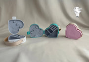 Heart-shaped plastic jewelry organizer with secure closure and leather handle