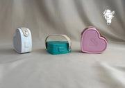 Heart-shaped plastic jewelry organizer with secure closure and leather handle