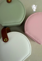 Round leather jewelry organizer with clasp closure and leather handle