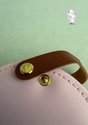 Round leather jewelry organizer with clasp closure and leather handle