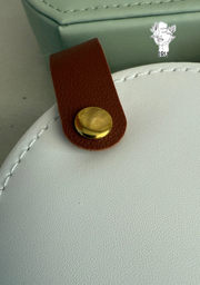 Round leather jewelry organizer with clasp closure and leather handle