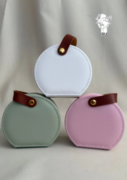 Round leather jewelry organizer with clasp closure and leather handle