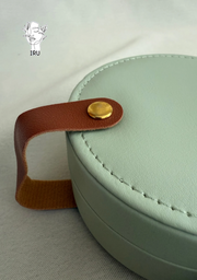 Round leather jewelry organizer with clasp closure and leather handle