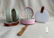 Round leather jewelry organizer with clasp closure and leather handle